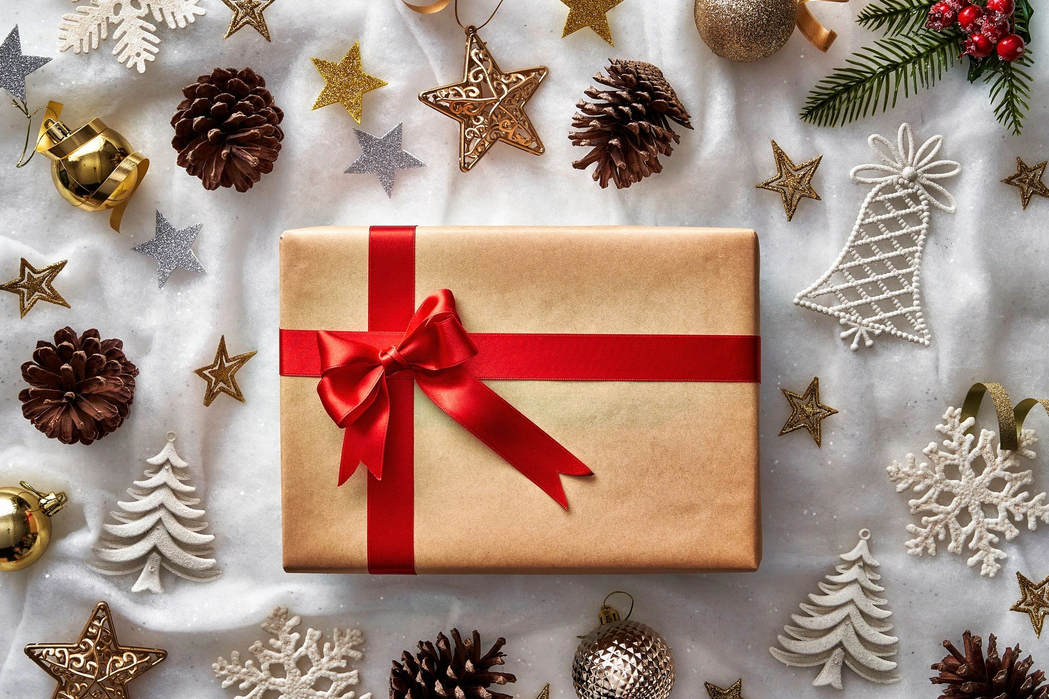 Seasonal gift and ornament flat lay on a soft background